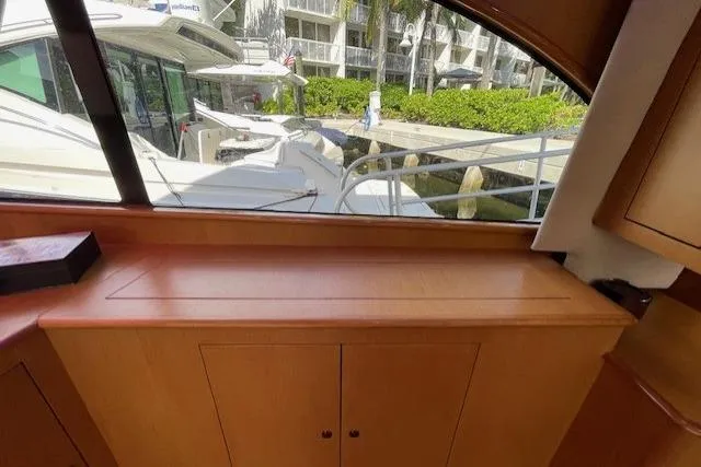 Slide: The Image of Interior view of 2003 Post Flybridge Convertible yacht with window overlooking marina. - 14