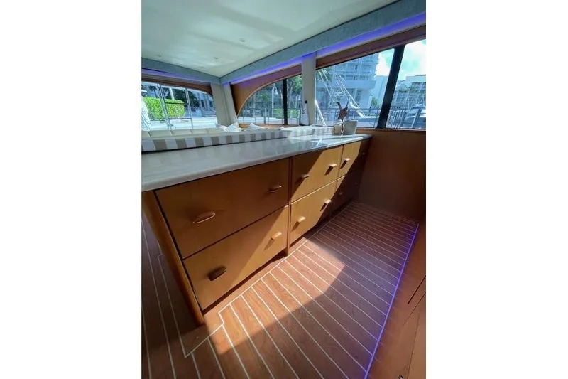 Slide: The Image of Interior of 2003 Post Flybridge Convertible yacht with wooden cabinetry and striped flooring. - 17