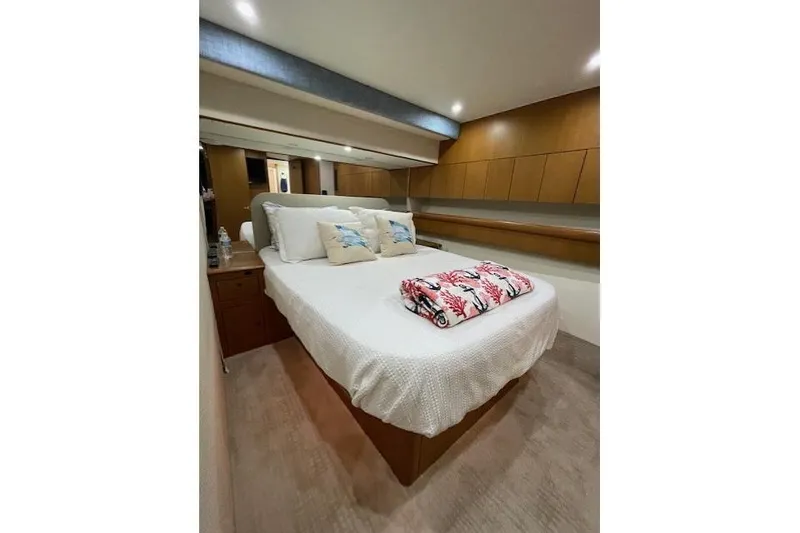 Slide: The Image of Luxurious cabin interior of 2003 Post Flybridge Convertible yacht with cozy bedding. - 22