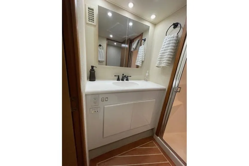 Slide: The Image of Narrow hallway inside 2003 Post Flybridge Convertible yacht with wooden flooring and stairs. - 33