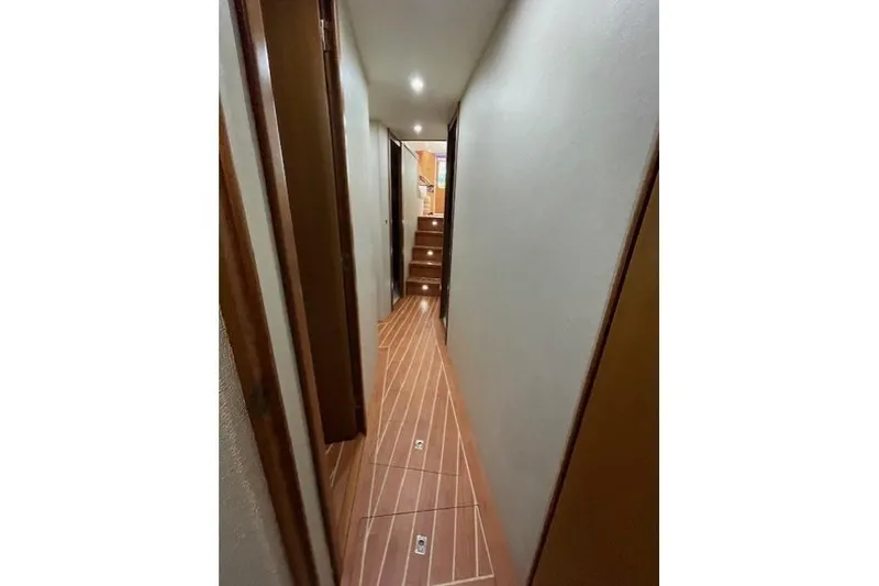 Slide: The Image of Interior of 2003 Post Flybridge Convertible yacht with wooden stairs and cozy bedroom. - 34