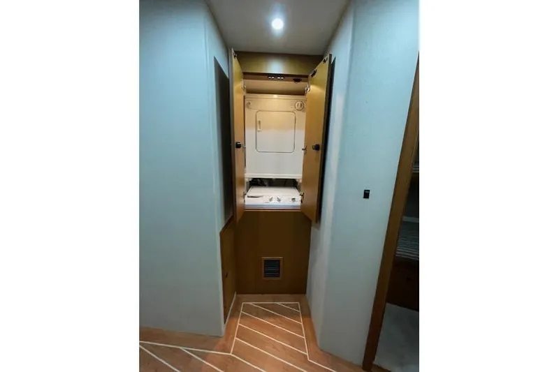 Slide: The Image of 2003 Post Flybridge Convertible cabin with bunk beds and wooden storage cabinet. - 37