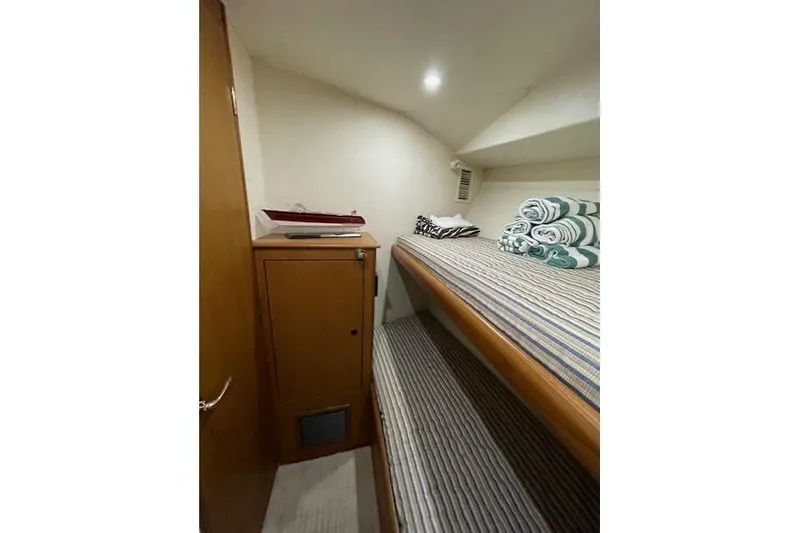Slide: The Image of Bunk beds in 2003 Post Flybridge Convertible yacht cabin with striped bedding and decorative pillows. - 38