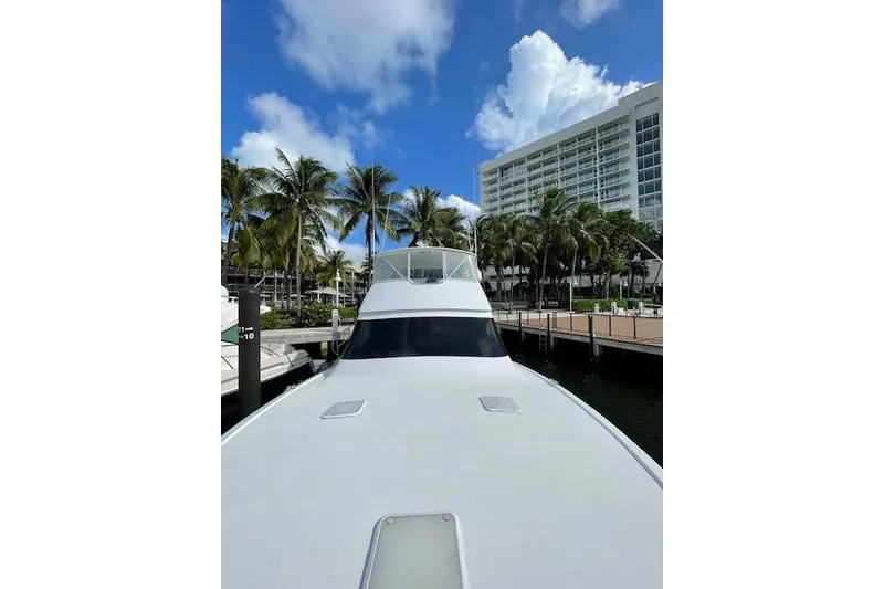 Slide: The Image of Bow of a 2003 Post Flybridge Convertible boat docked by a canal. - 42