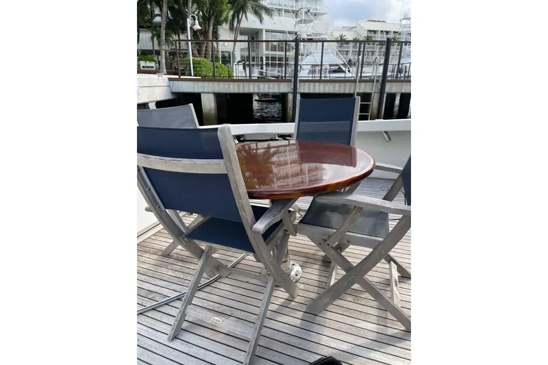 Slide: The Image of 2003 Post Flybridge Convertible yacht docked, featuring spacious deck and flybridge. - 44