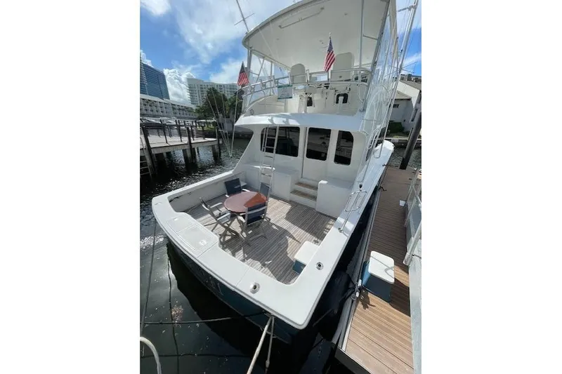 Slide: The Image of 2003 Post Flybridge Convertible yacht helm with modern navigation equipment and panoramic windows. - 46