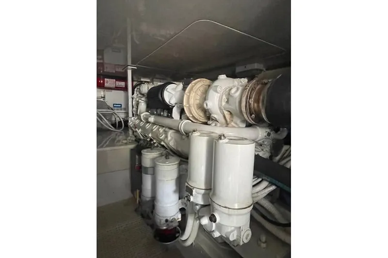 Slide: The Image of Engine compartment of a 2003 Post Flybridge Convertible boat, showing pipes and fittings. - 53