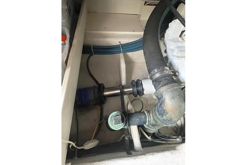 Slide: The Image of Engine compartment of 2003 Post Flybridge Convertible with visible pipes and components. - 54