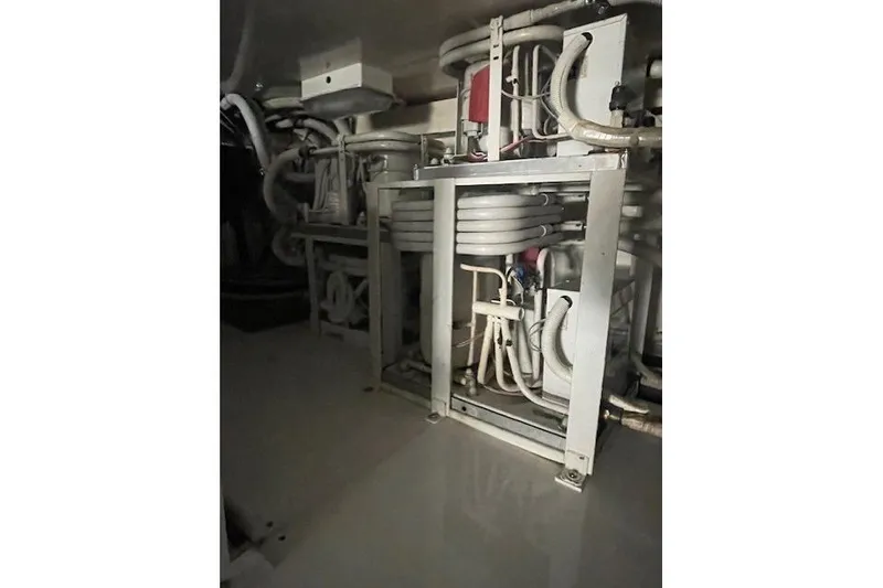 Slide: The Image of Engine room of 2003 Post Flybridge Convertible, showcasing filters and components. - 56