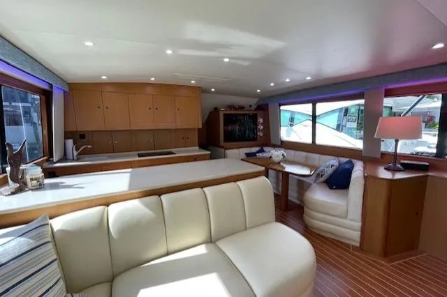 Slide: The Image of Luxurious interior of 2003 Post Flybridge Convertible yacht with modern seating and ample natural light. - 6