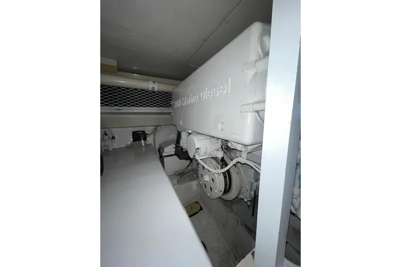 Slide: The Image of Engine room of a 2003 Post Flybridge Convertible boat, showcasing machinery and components. - 62