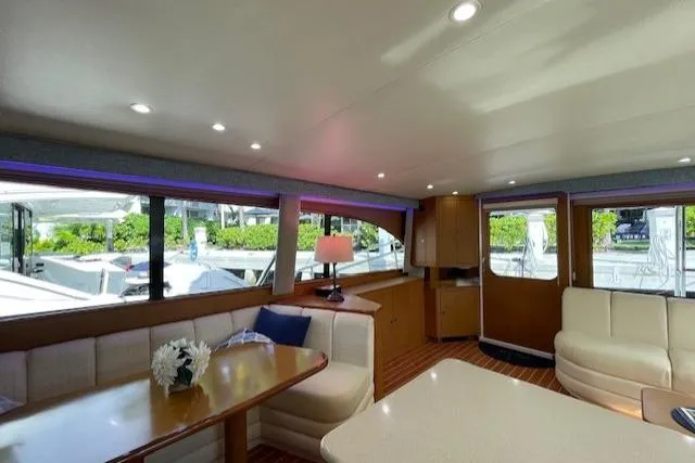 Slide: The Image of Luxurious interior of 2003 Post Flybridge Convertible yacht with elegant seating and large windows. - 7