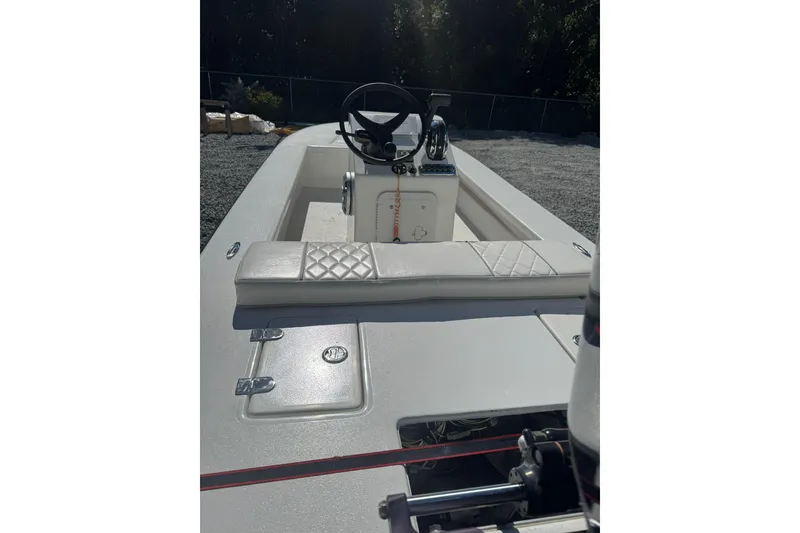 Slide: The Image of 2023 Lagoon 14 boat interior with steering wheel and cushioned seating. - 4