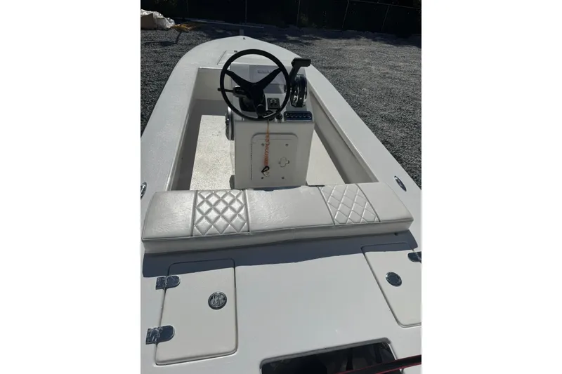 Slide: The Image of 2023 Lagoon 14 boat interior with steering console and cushioned seating. - 5