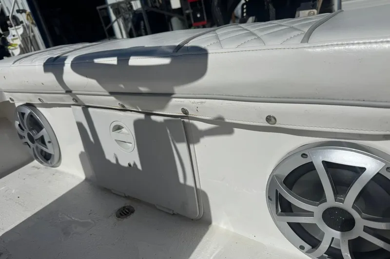 Slide: The Image of 2023 Lagoon 14 boat interior with speakers and cushioned seating. - 7