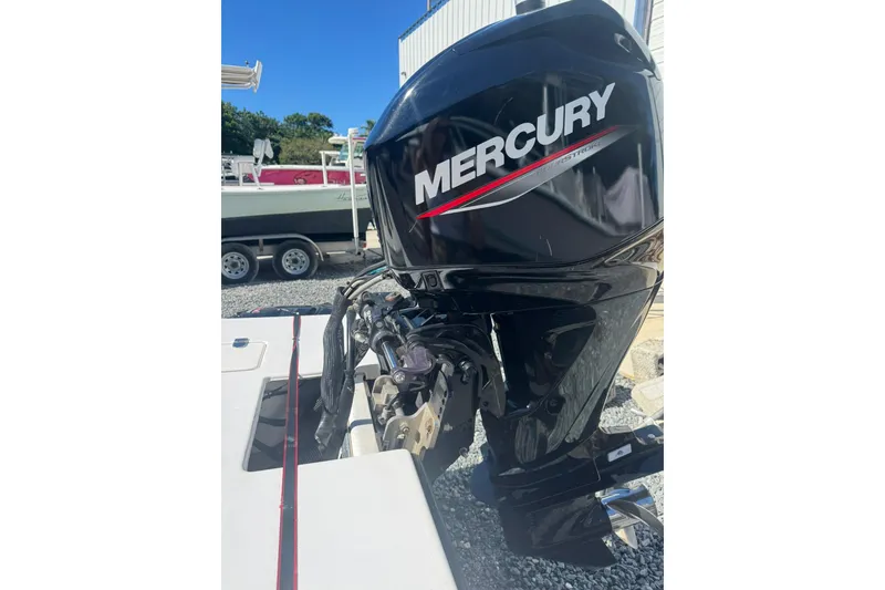 Slide: The Image of Mercury outboard motor on a 2023 Lagoon 14 boat, parked on gravel. - 8