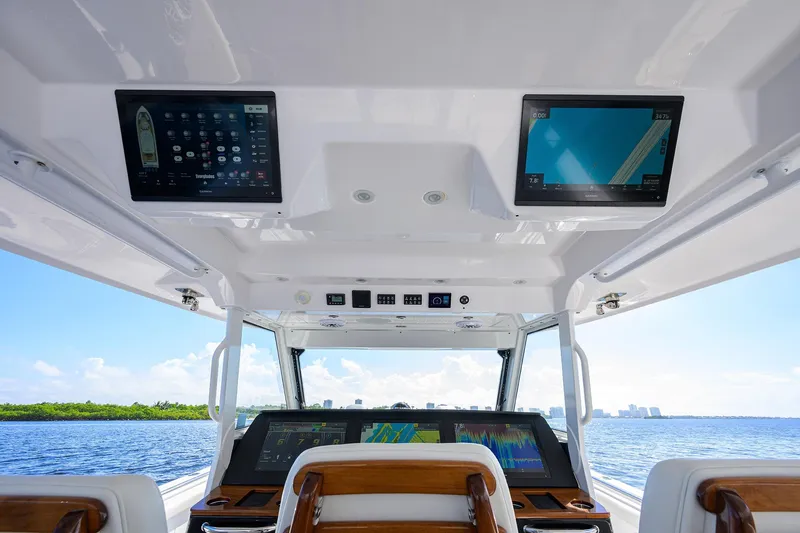 Slide: The Image of 2024 Everglades 455 Center Console boat interior with advanced navigation displays. - 11
