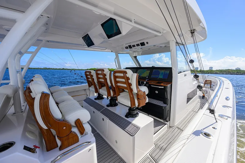 Slide: The Image of 2024 Everglades 455 Center Console boat interior with luxurious seating and advanced navigation systems. - 12