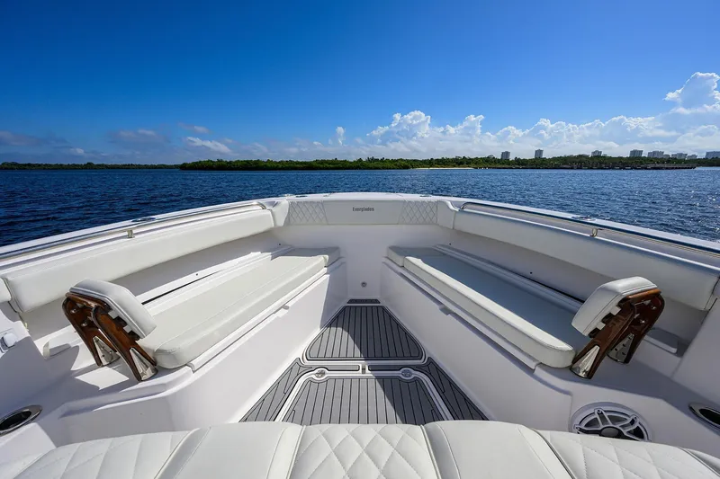 Slide: The Image of 2024 Everglades 455 Center Console boat interior with white seating, on a sunny day. - 19
