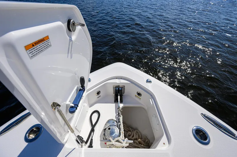 Slide: The Image of 2024 Everglades 455 Center Console anchor compartment with open hatch, on calm water. - 23
