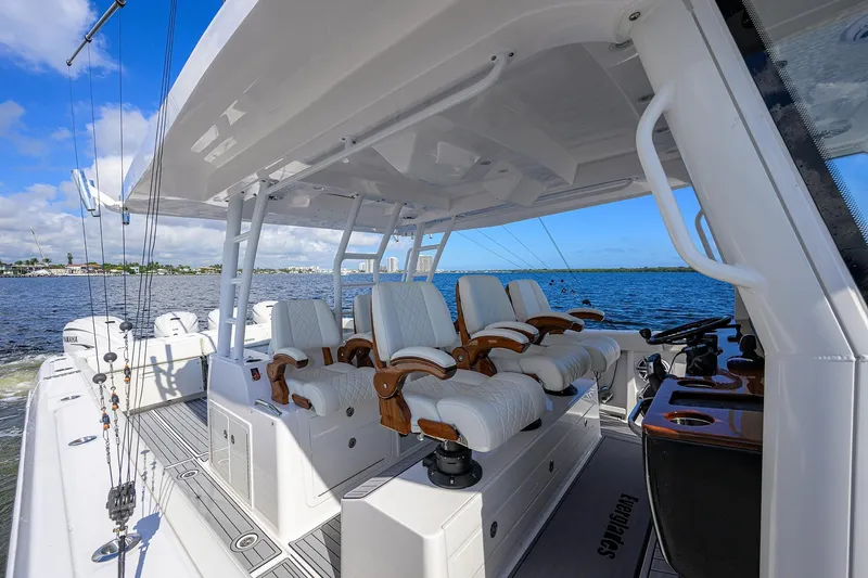 Slide: The Image of 2024 Everglades 455 Center Console boat interior with luxurious seating on open water. - 25