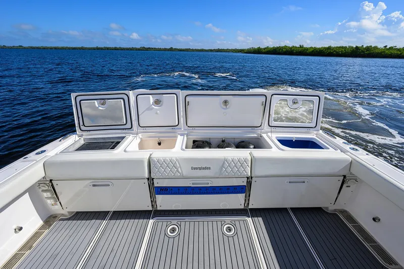 Slide: The Image of 2024 Everglades 455 Center Console boat interior with open storage compartments on the water. - 29