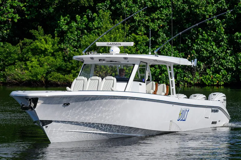 Slide: The Image of 2024 Everglades 455 Center Console boat cruising on a calm waterway. - 3