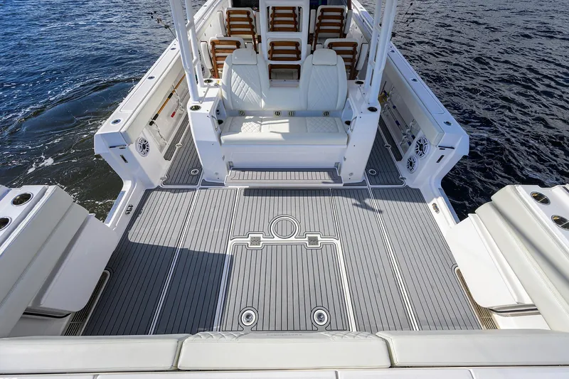 Slide: The Image of 2024 Everglades 455 Center Console boat interior with seating and deck, on water. - 32