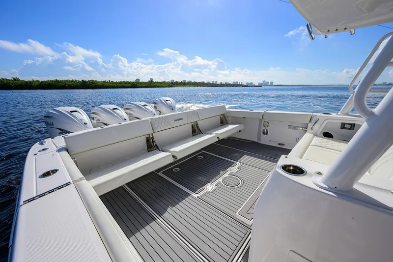 Slide: The Image of 2024 Everglades 455 Center Console boat with spacious deck and multiple outboard engines. - 33