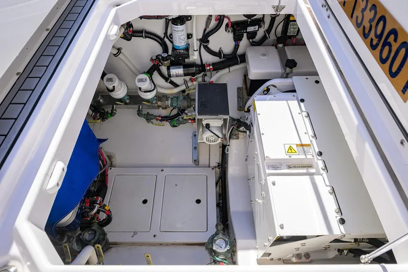 Slide: The Image of 2024 Everglades 455 Center Console engine compartment with advanced equipment and wiring. - 45