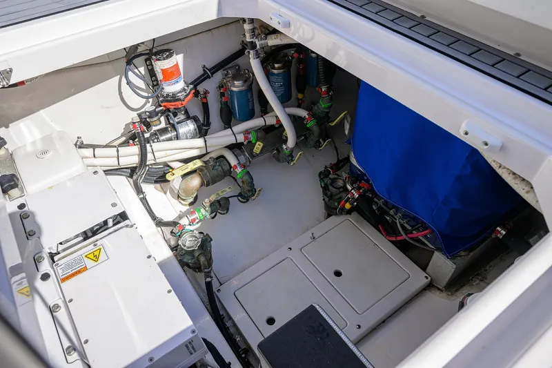 Slide: The Image of 2024 Everglades 455 Center Console engine compartment with wiring and mechanical components. - 46