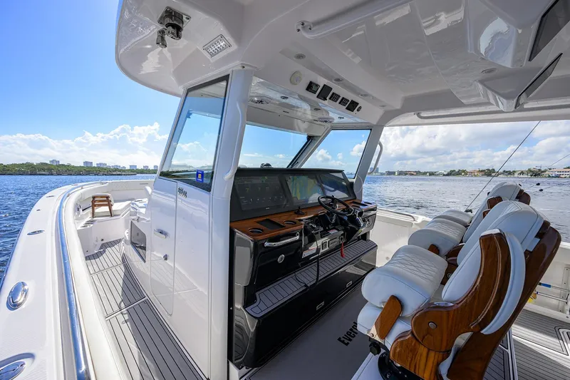 Slide: The Image of 2024 Everglades 455 Center Console boat interior with luxurious seating and advanced navigation system. - 7