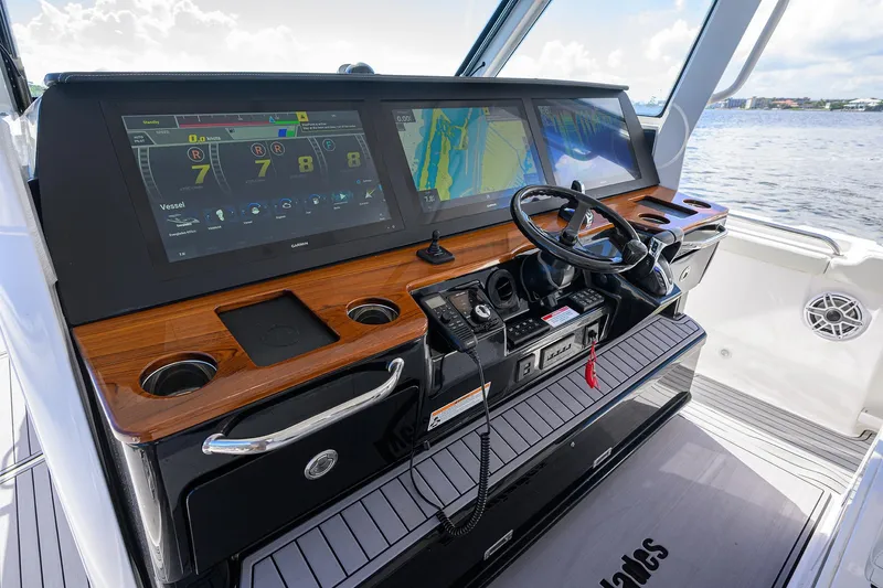 Slide: The Image of 2024 Everglades 455 Center Console helm with advanced navigation displays and controls. - 8