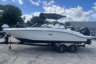 The Image of 2023 Sea Ray SPX 210 Outboard boat on trailer under blue sky. - 0
