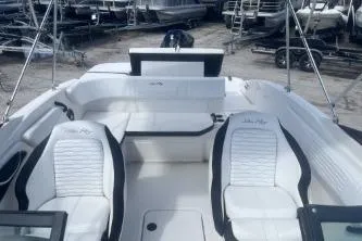 Slide: The Image of 2023 Sea Ray SPX 210 Outboard boat interior with white seating and sleek design. - 10