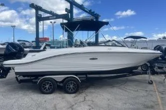 Slide: The Image of 2023 Sea Ray SPX 210 Outboard boat on trailer under blue sky. - 2