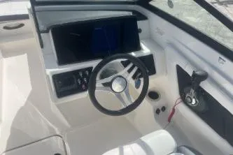 Slide: The Image of 2023 Sea Ray SPX 210 Outboard boat cockpit with steering wheel and control panel. - 8
