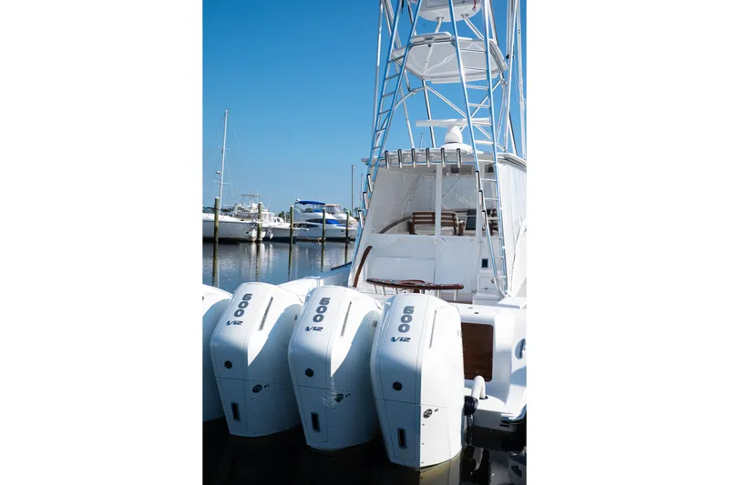 Slide: The Image of 2026 Front Runner 47' Walk Around boat with powerful V12 engines docked at marina. - 12