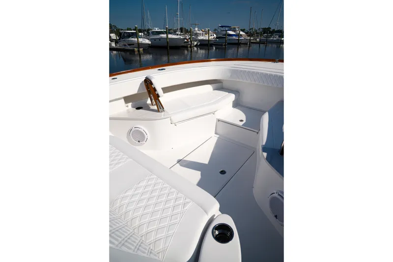 Slide: The Image of 2026 Front Runner 47' Walk Around boat interior with white seating and marina view. - 9
