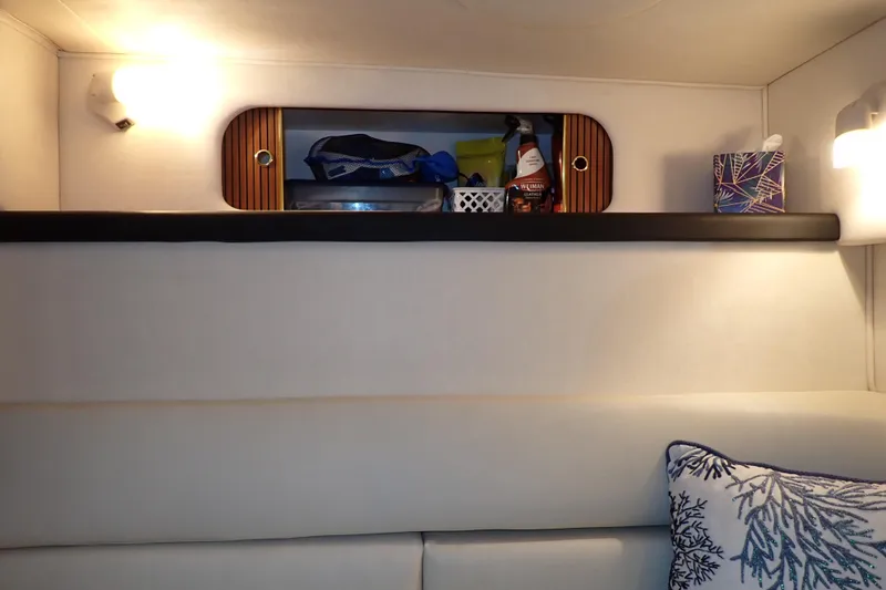 Slide: The Image of Interior of 2002 Sea Ray 340 Sundancer with shelf, lighting, and decorative pillow. - 112