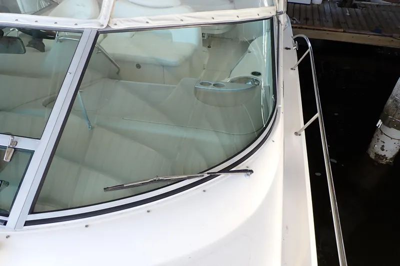 Slide: The Image of 2002 Sea Ray 340 Sundancer boat with sleek windshield and white interior. - 125