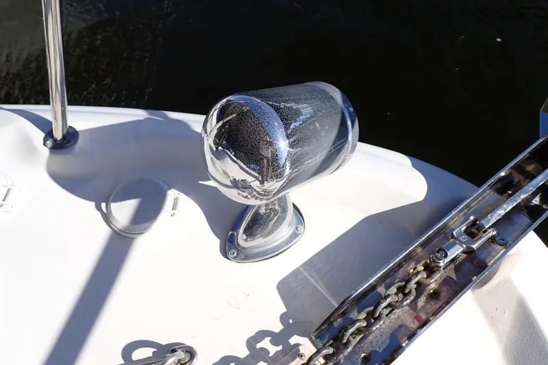 Slide: The Image of Chrome anchor winch on 2002 Sea Ray 340 Sundancer boat deck, near water. - 126