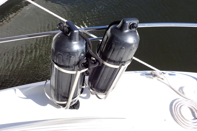 Slide: The Image of Two black fenders secured on a 2002 Sea Ray 340 Sundancer boat deck. - 128