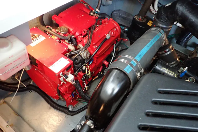 Slide: The Image of Engine compartment of a 2002 Sea Ray 340 Sundancer with red engine components. - 133