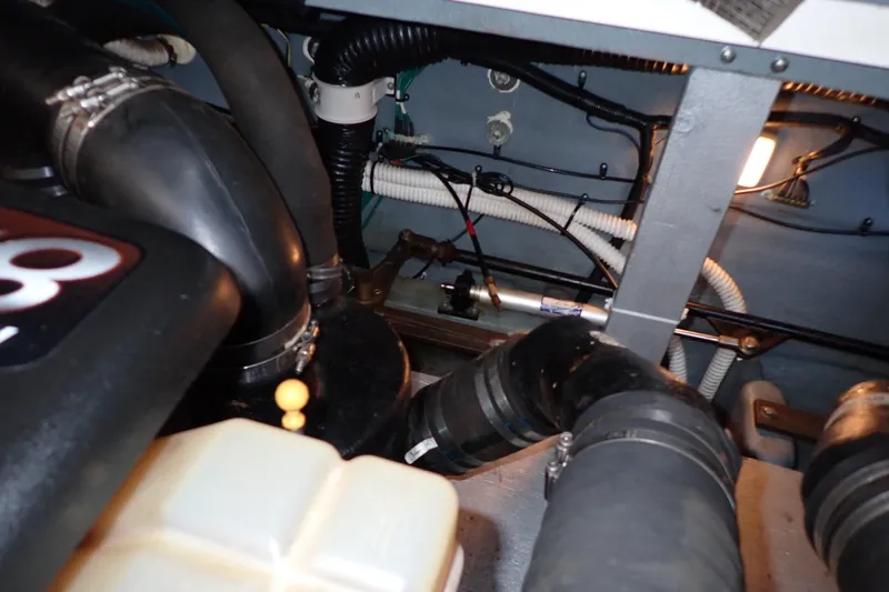 Slide: The Image of Engine compartment of 2002 Sea Ray 340 Sundancer with visible hoses and wiring. - 141