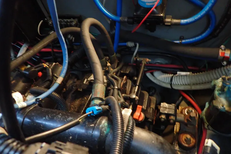 Slide: The Image of Engine compartment of a 2002 Sea Ray 340 Sundancer with visible wiring and hoses. - 142