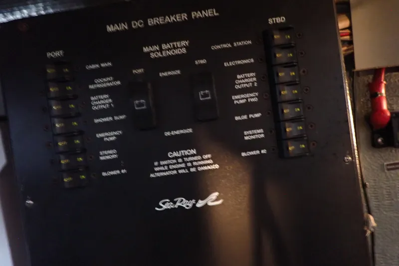 Slide: The Image of Main DC breaker panel on 2002 Sea Ray 340 Sundancer boat, showing switches and solenoids. - 143