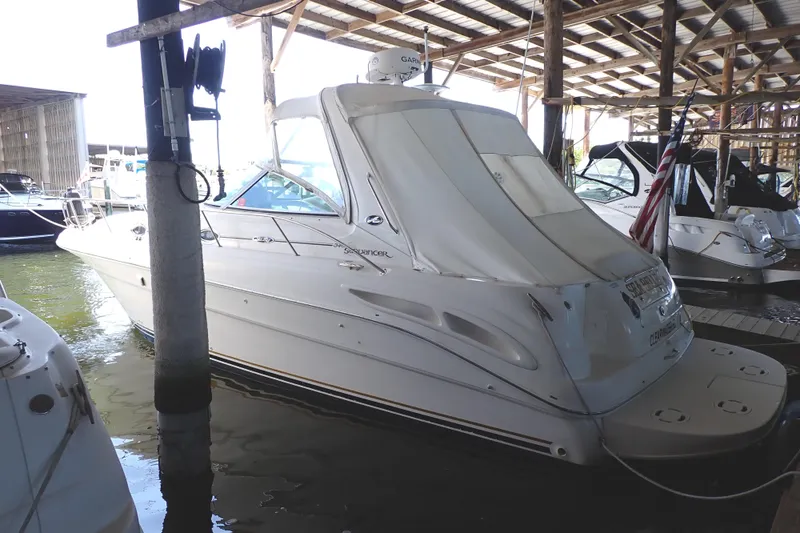 Slide: The Image of 2002 Sea Ray 340 Sundancer docked in a covered marina. - 148