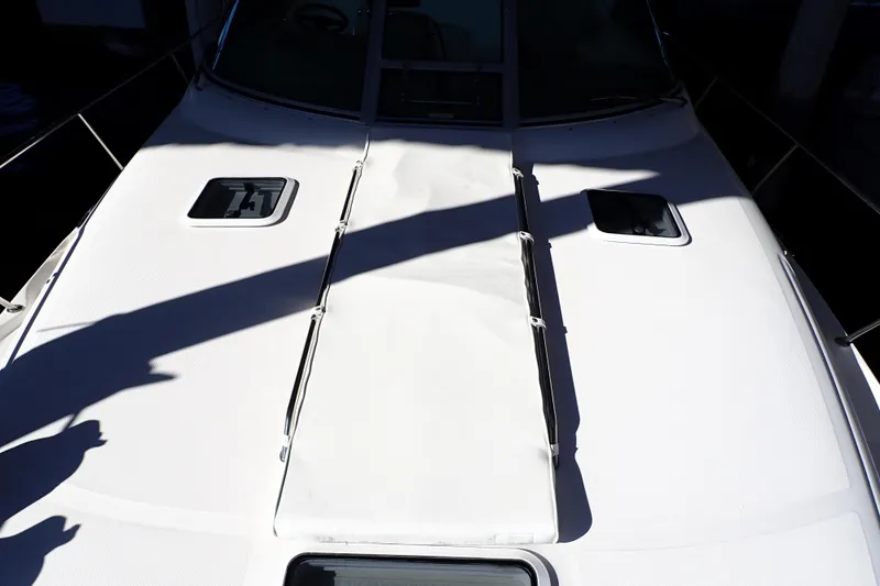 Slide: The Image of 2002 Sea Ray 340 Sundancer boat deck with hatches and shadows. - 16