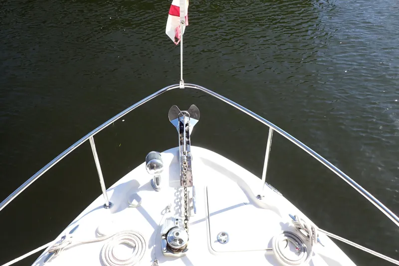 Slide: The Image of Bow view of 2002 Sea Ray 340 Sundancer yacht with anchor and flag. - 20